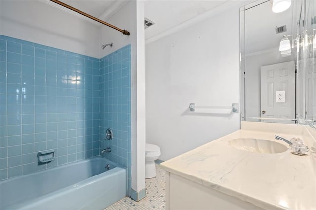 full bathroom with toilet, crown molding, tiled shower / bath, vanity, and tile patterned flooring