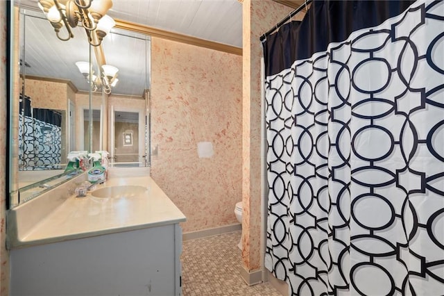 bathroom with an inviting chandelier, vanity, ornamental molding, and toilet