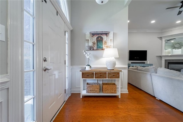 entryway with ornamental molding, ceiling fan, and hardwood / wood-style floors