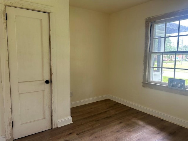 unfurnished room featuring dark wood finished floors and baseboards