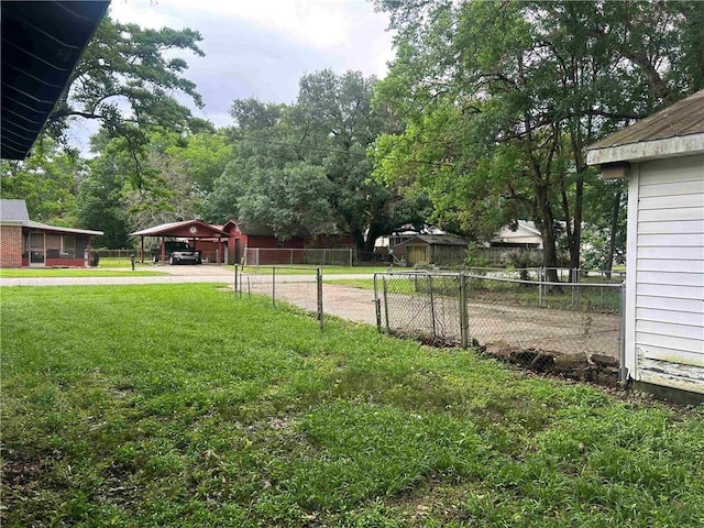 view of yard with driveway and a carport