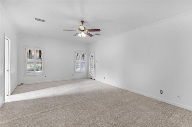 carpeted spare room featuring ornamental molding and ceiling fan