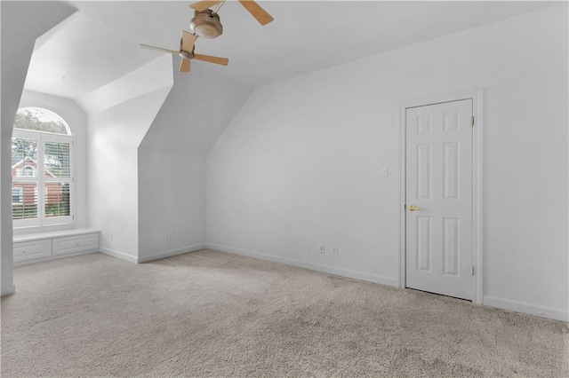 bonus room featuring vaulted ceiling, light colored carpet, and ceiling fan