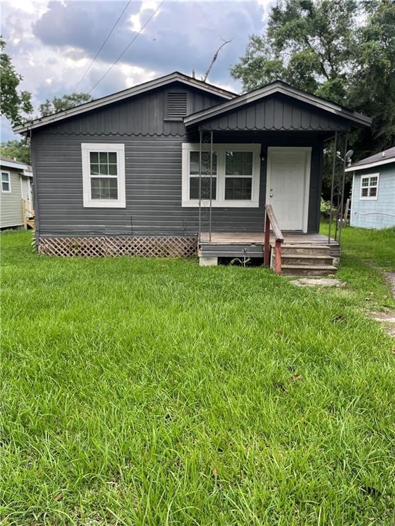 1053 Lubel Ave, Mobile, AL 36617 - rear view of house with a yard, board and batten siding, and a porch