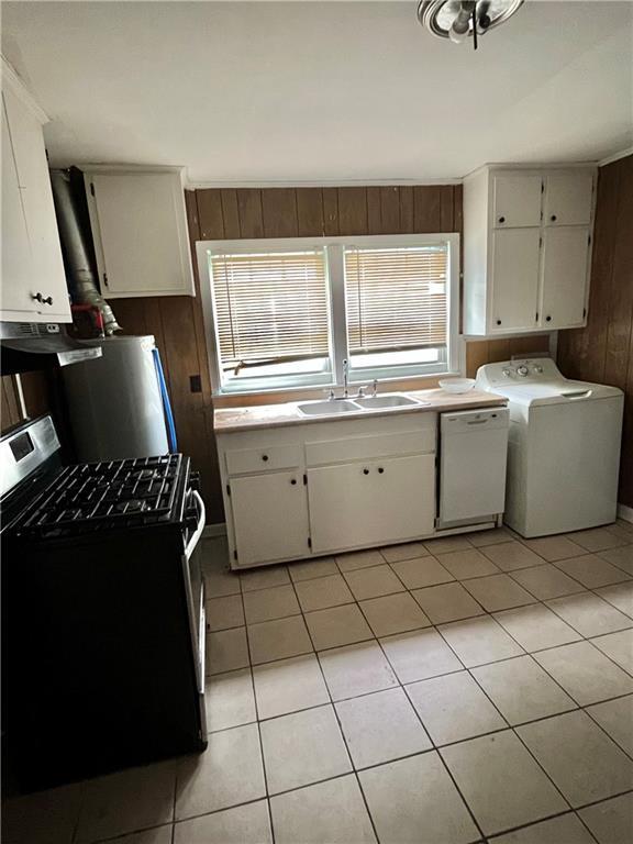 1053 Lubel Ave, Mobile, AL 36617 - kitchen with stainless steel range with gas cooktop, washer / dryer, white dishwasher, wood walls, and white cabinetry