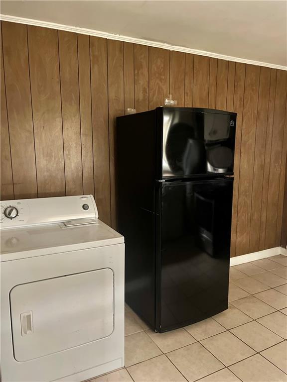 1053 Lubel Ave, Mobile, AL 36617 - laundry room featuring washer / clothes dryer, wood walls, and light tile patterned floors