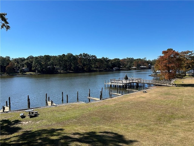 dock area featuring a water view and a lawn