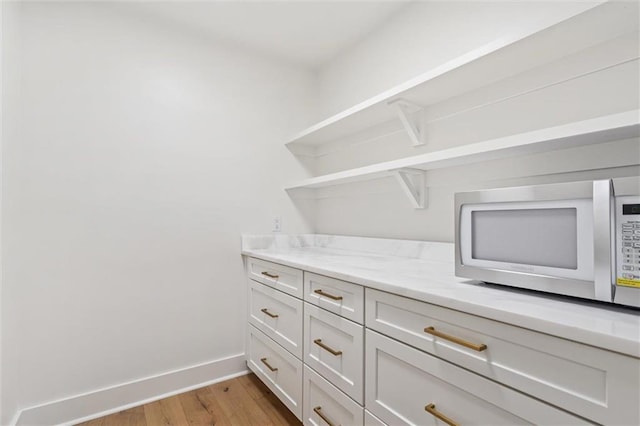 walk in closet with light wood-type flooring