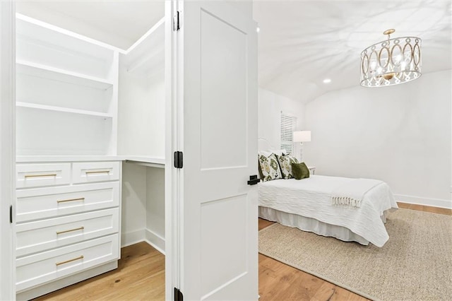 bedroom featuring lofted ceiling and light wood-type flooring