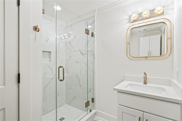 bathroom with crown molding, vanity, and a shower with shower door