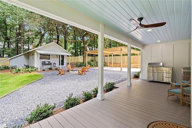 wooden terrace with a grill and ceiling fan