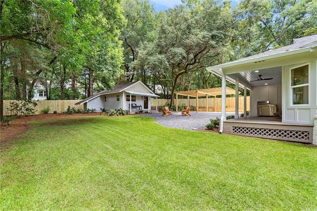 view of yard with ceiling fan and an outdoor structure