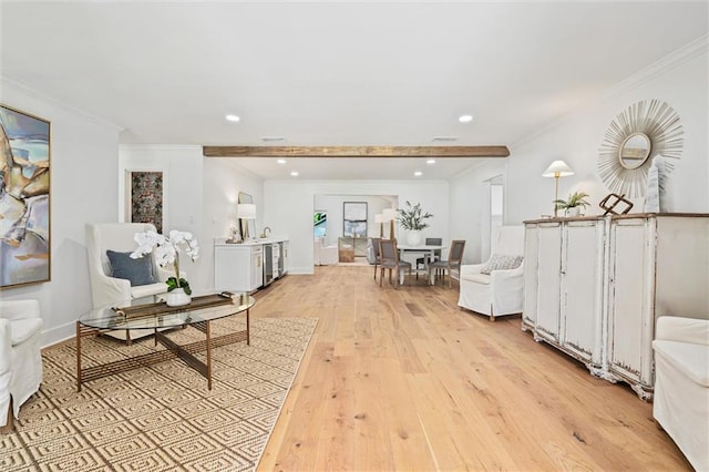 interior space featuring beam ceiling, crown molding, and light wood-type flooring