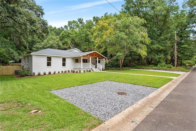 view of front facade featuring a front yard, a porch, and central AC unit