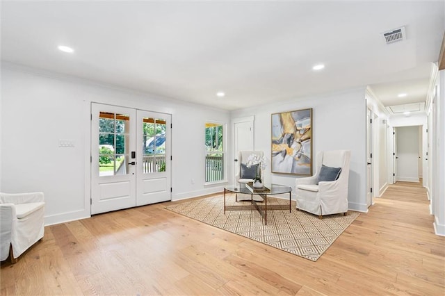 living area featuring light hardwood / wood-style flooring and french doors