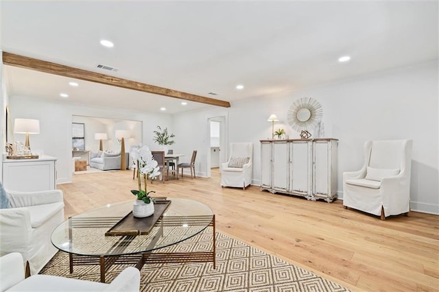 living room with beamed ceiling and light hardwood / wood-style floors