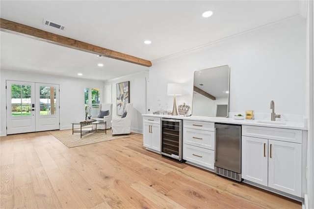 bar featuring white cabinets, beam ceiling, wine cooler, and sink