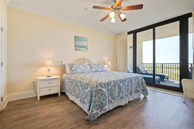 bedroom with ornamental molding, a wall of windows, dark wood finished floors, and access to exterior