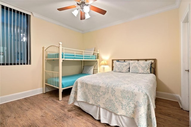 bedroom with ceiling fan, baseboards, crown molding, and wood finished floors