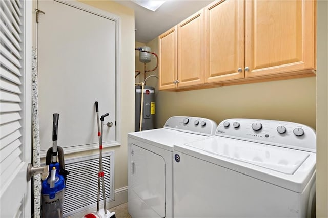 washroom with cabinet space, washer and clothes dryer, and electric water heater