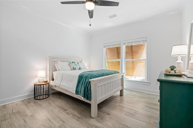 bedroom with light hardwood / wood-style floors and ceiling fan