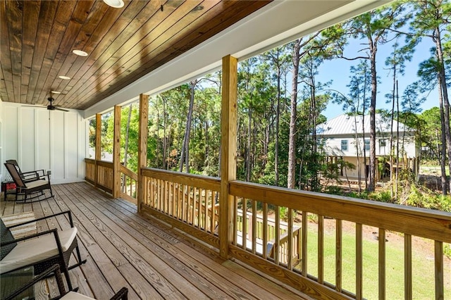 wooden deck featuring a lawn