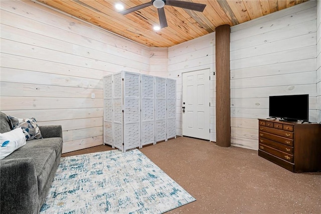 bedroom with ceiling fan, wood walls, and wood ceiling