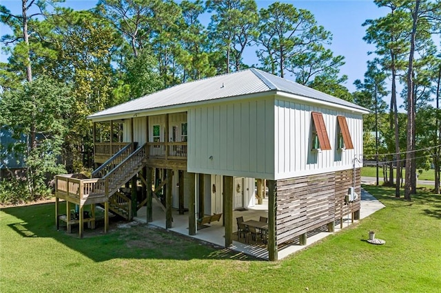 rear view of property with a lawn and a patio area