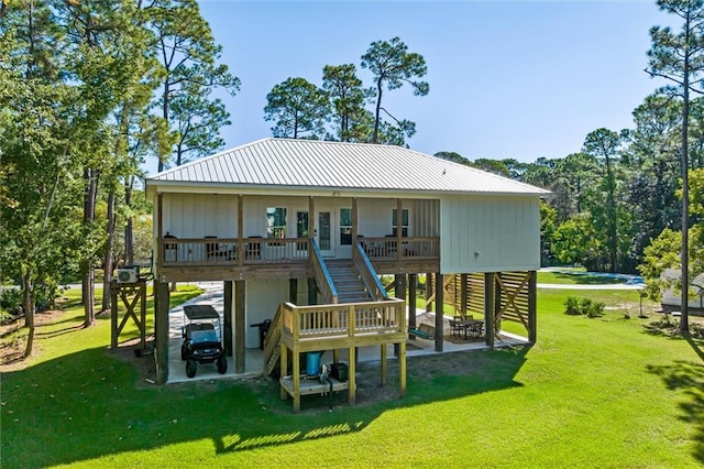 rear view of house featuring a lawn