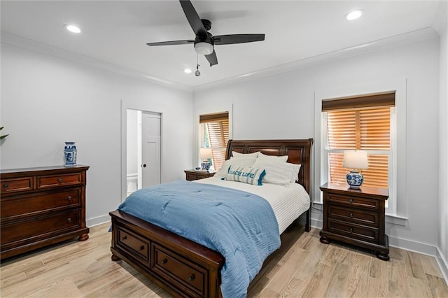 bedroom with light hardwood / wood-style floors, ornamental molding, and ceiling fan