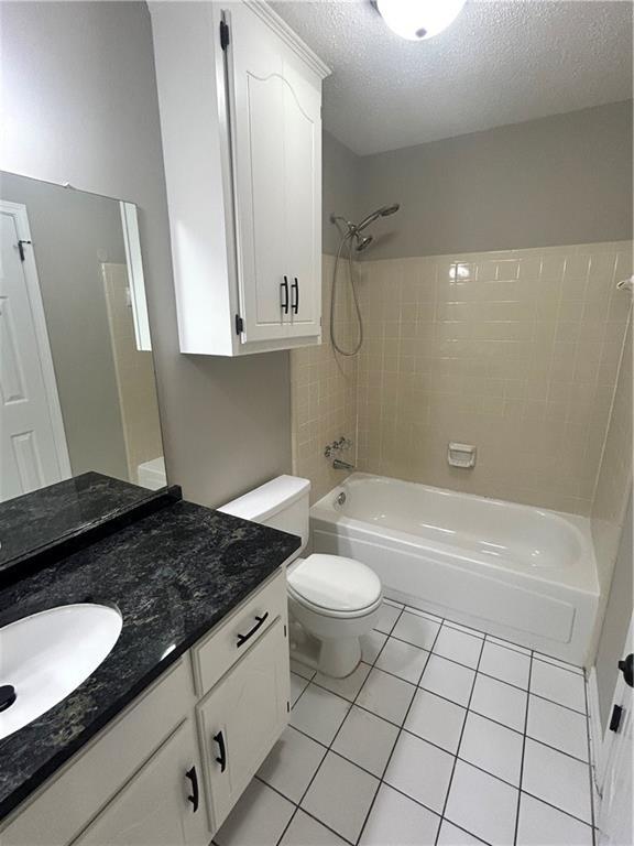 3120 Wellborne Dr W, Mobile, AL 36695 - full bath with tile patterned flooring, a textured ceiling, shower / bathtub combination, toilet, and vanity