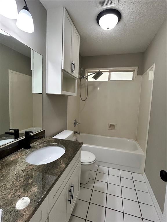 3120 Wellborne Dr W, Mobile, AL 36695 - full bathroom with toilet, tile patterned floors, a textured ceiling, bathing tub / shower combination, and vanity