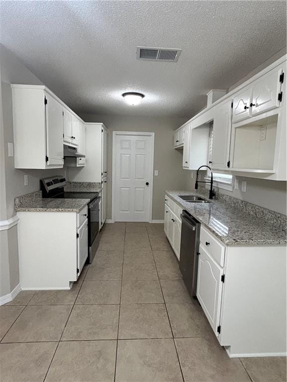 3120 Wellborne Dr W, Mobile, AL 36695 - kitchen featuring stainless steel appliances, a sink, white cabinets, a textured ceiling, and light tile patterned floors