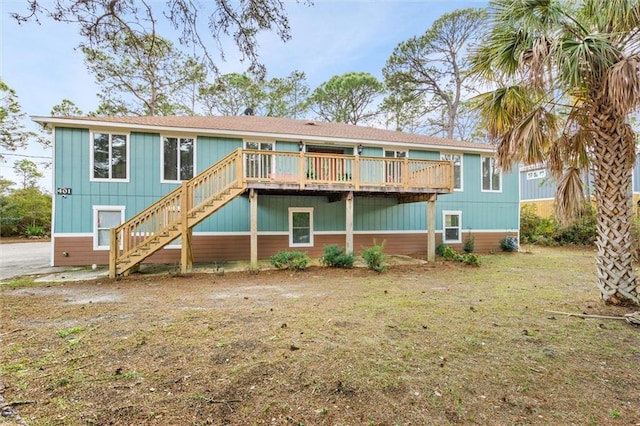 back of house with stairs and a deck