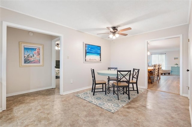 dining area with baseboards, a ceiling fan, and crown molding