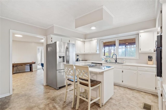 kitchen featuring a sink, white cabinetry, visible vents, light countertops, and stainless steel fridge with ice dispenser