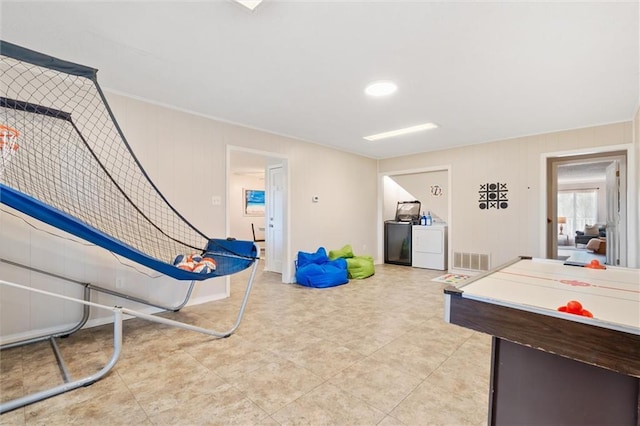 playroom with washing machine and dryer and visible vents