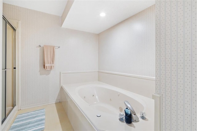 full bathroom with a whirlpool tub, a stall shower, and wallpapered walls