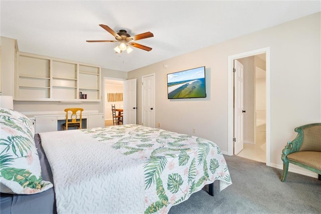 carpeted bedroom featuring ceiling fan, built in desk, and baseboards