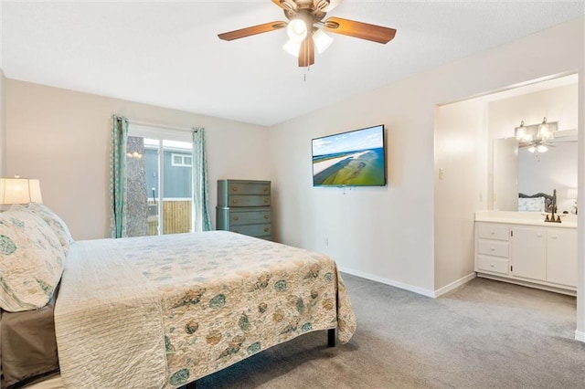 bedroom featuring light carpet, connected bathroom, baseboards, and ceiling fan