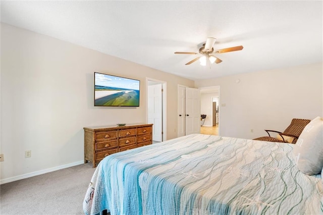 bedroom featuring baseboards, a ceiling fan, and light colored carpet