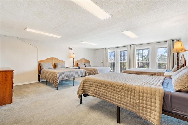 bedroom with baseboards, carpet, visible vents, and a textured ceiling