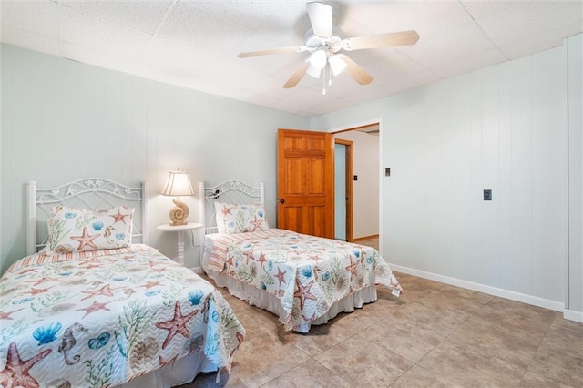 bedroom with ceiling fan and baseboards