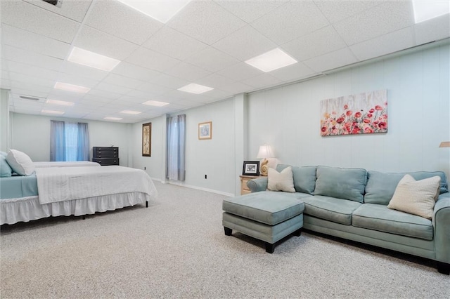 bedroom featuring carpet floors, a drop ceiling, visible vents, and baseboards