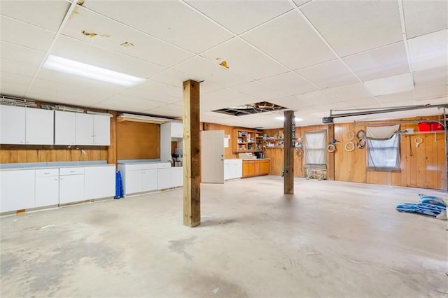 garage featuring wooden walls and washer and clothes dryer