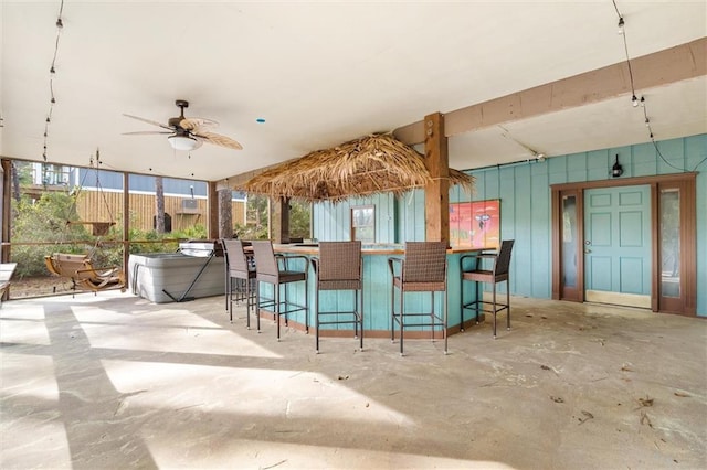 interior space with ceiling fan, concrete floors, and a wealth of natural light