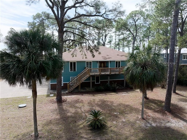 back of house featuring a deck and stairway