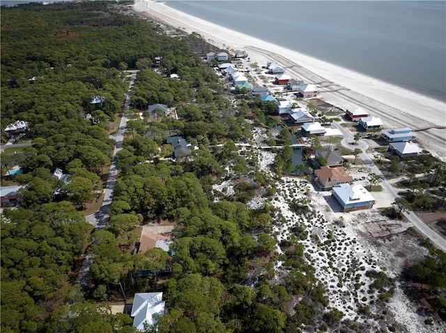 birds eye view of property with a view of the beach and a water view