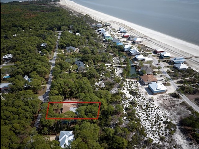 bird's eye view with a water view and a beach view