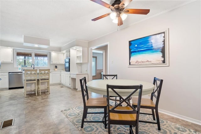 dining area featuring visible vents, crown molding, baseboards, and ceiling fan